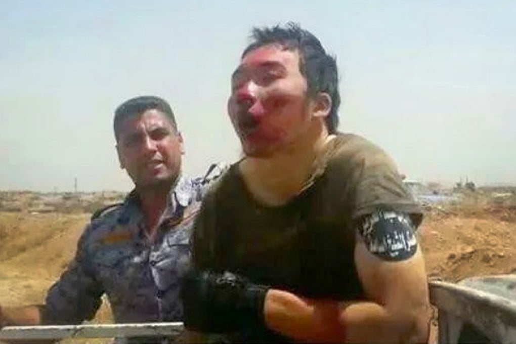 The captured militant is seen guarded by an Iraqi soldier. Photos: Iraqi Ministry of Defence