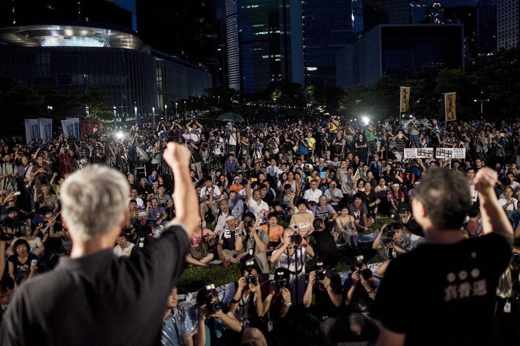 Benny Tai (right), co-founder of the Occupy Central movement, rallies with democracy activists next to the Hong Kong government complex on August 31. Photo: AFP
