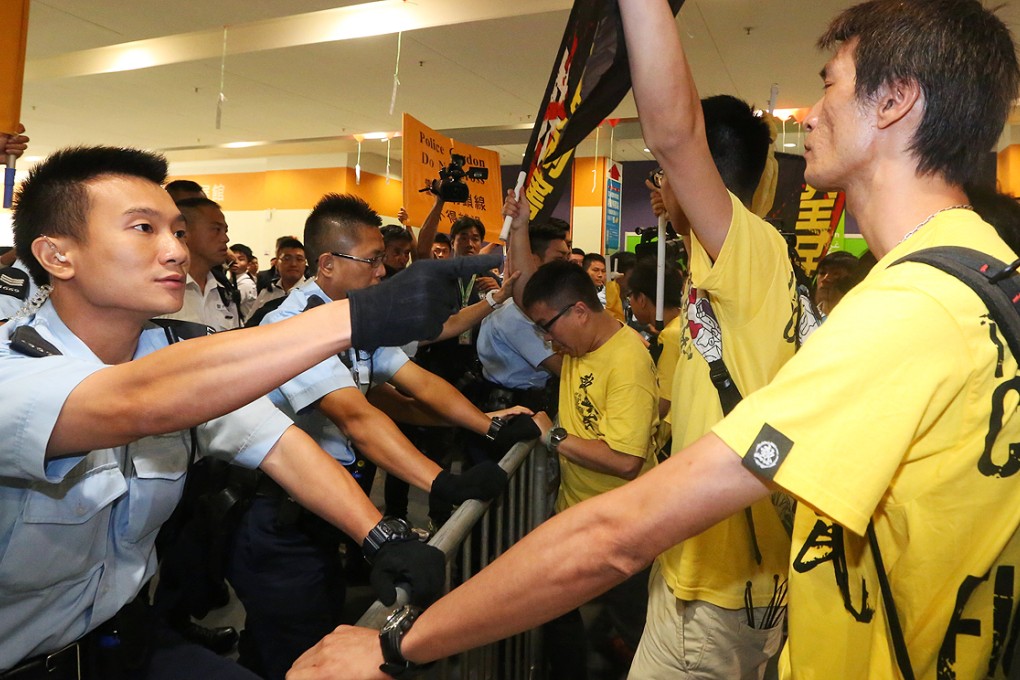 Police and protesters face off over a metal barricade before pepper spray is used, during a protest in Hong Kong on September 1, 2014. Photo: SCMP/Felix Wong