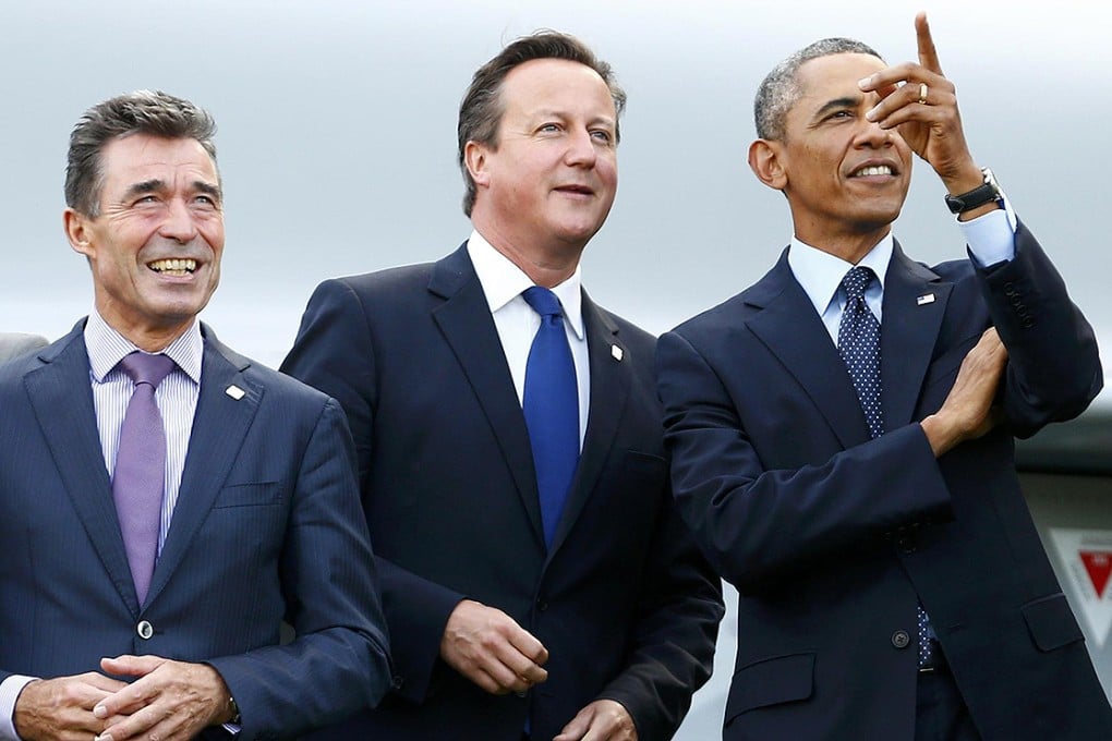 Nato chief Anders Fogh Rasmussen (left), Britain's David Cameron and Barack Obama watch an aerobatic show at the summit. Photo: Reuters