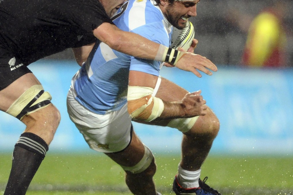 Argentina's Juan Martin Fernandez Lobbe is tackled by All Blacks skipper Richie McCaw in New Zealand's 28-9 win in Napier. McCaw needed treatment after being knocked by Tomás Lavanini. Photo: AP