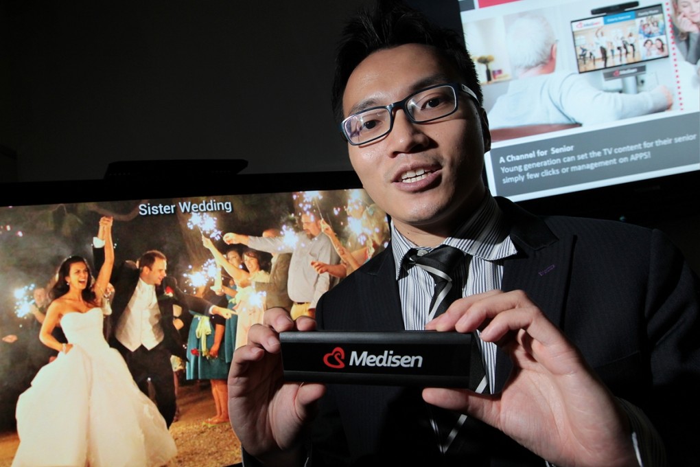 The family channel: Joe Wong with the system which can turn televisions into a social-media platform. Photo: Bruce Yan
