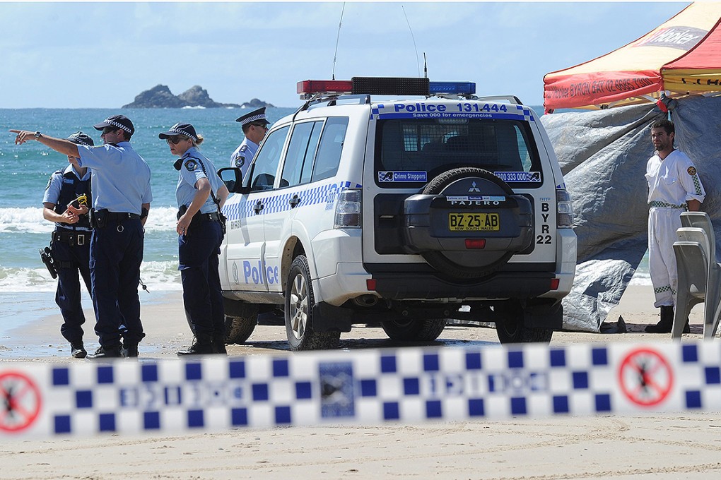 Australian police inspect Clarkes Beach, Byron Bay, after a swimmer died in a shark attack. Photo: EPA