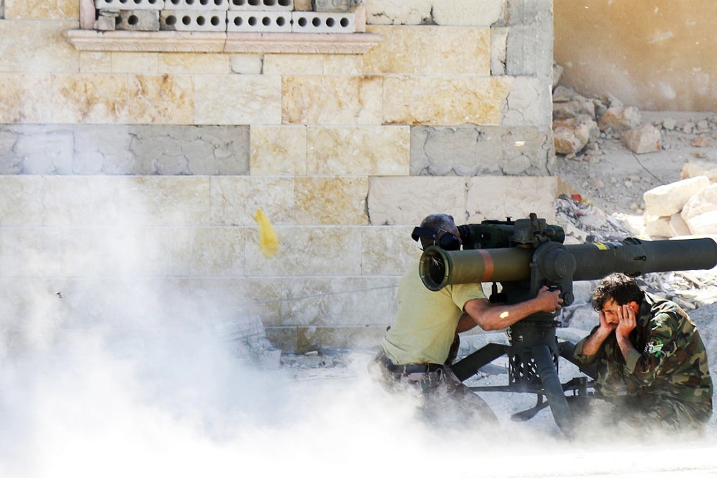 Rebel fighters fire an anti-tank weapon towards forces loyal to Syrian President Bashar al-Assad. Photo: Reuters