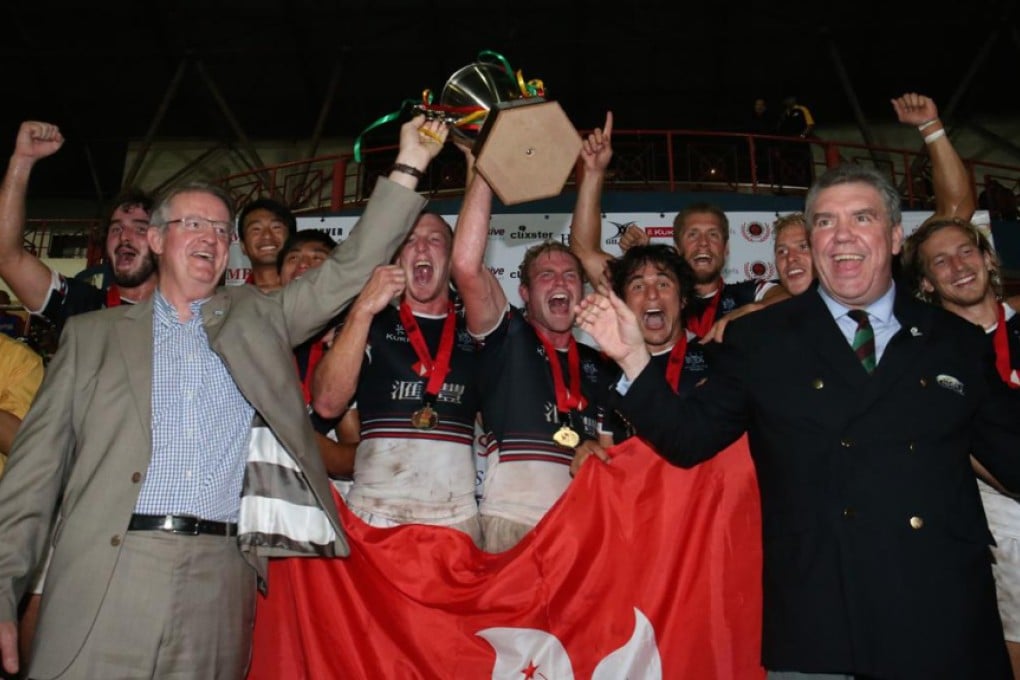 IRB chairman Bernard Lapasset and ARFU chief Trevor Gregory celebrate with Hong Kong's players. Photo: ARFU