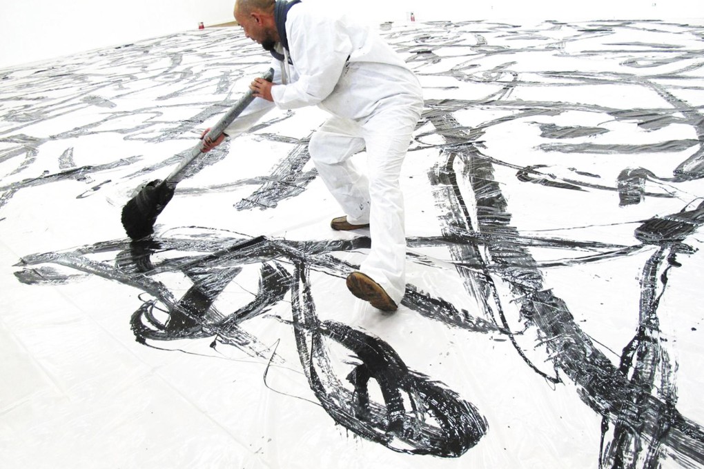 BIG PICTURE: Qin Feng at work in the studio.