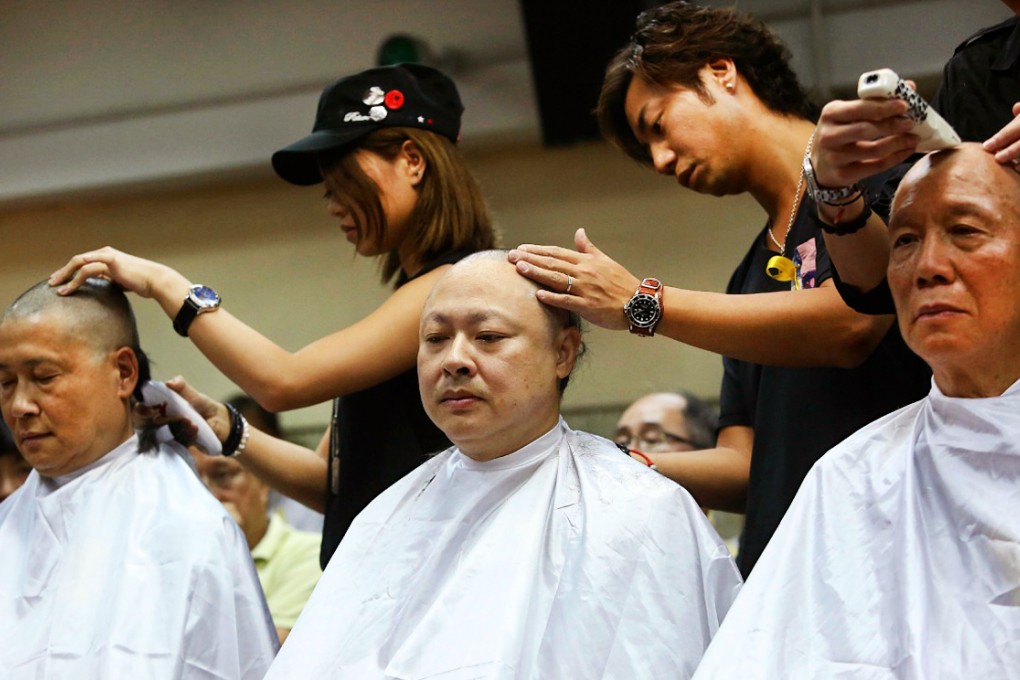 (From left) Dr Chan Kin-man, Benny Tai Yiu-ting and Reverend Chu Yiu-ming have their heads shaved on Tuesday. Photo: Sam Tsang