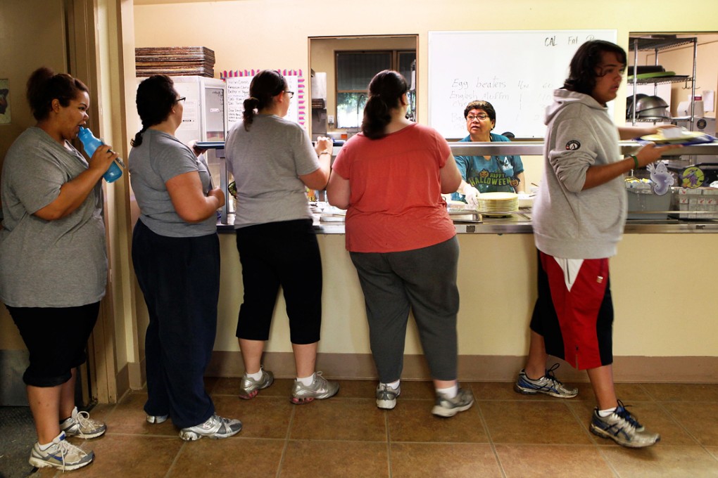 Students wait in line to get a meal at Wellspring Academy, which is a special school that helps teens and college level students lose weight along with academic courses. Photo: AFP