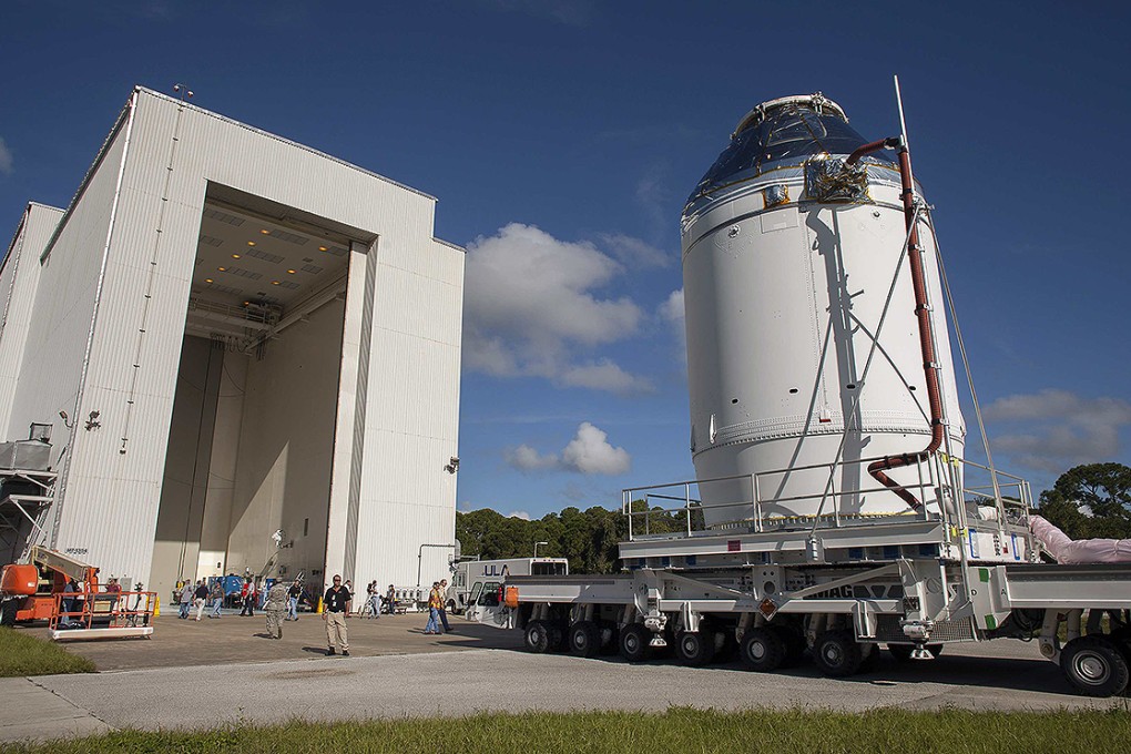 The Orion capsule sits on top of the service module as it is moved from the Operations & Checkout Building to the Payload Hazardous Servicing Facility at Kennedy Space Centre. Photo: Reuters