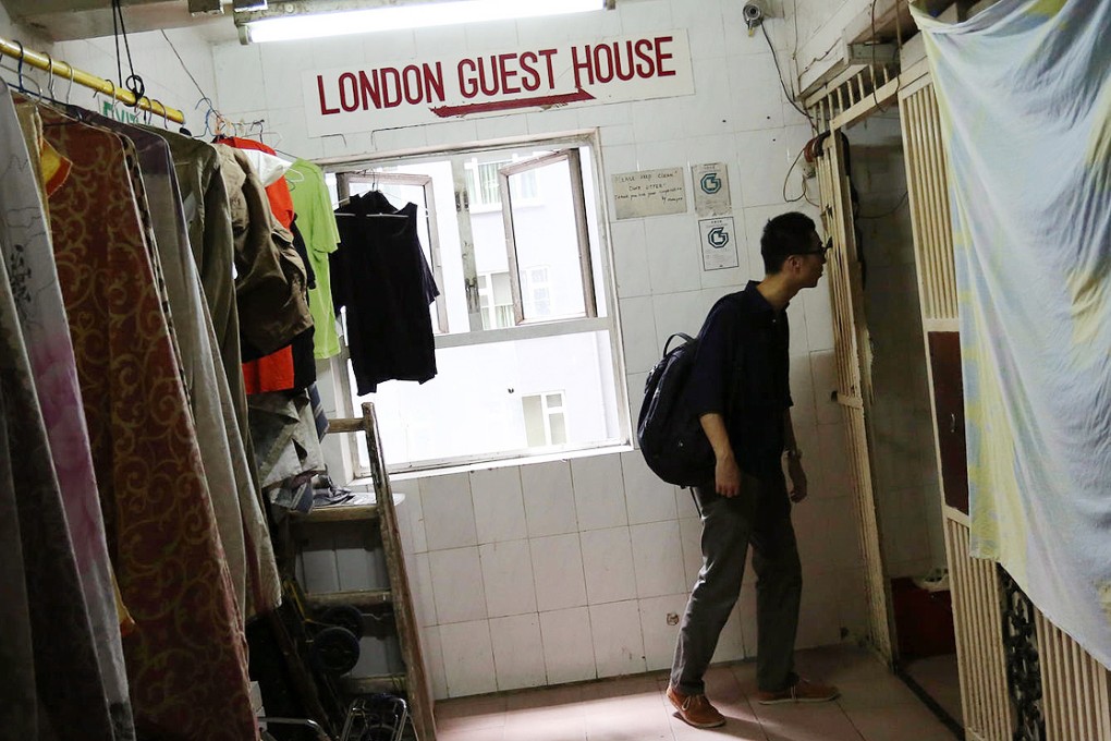 A man checks out a room in one of the city's many guest houses. Such hostels provide about 10 per cent of Hong Kong's temporary accommodation. Photo: Nora Tam