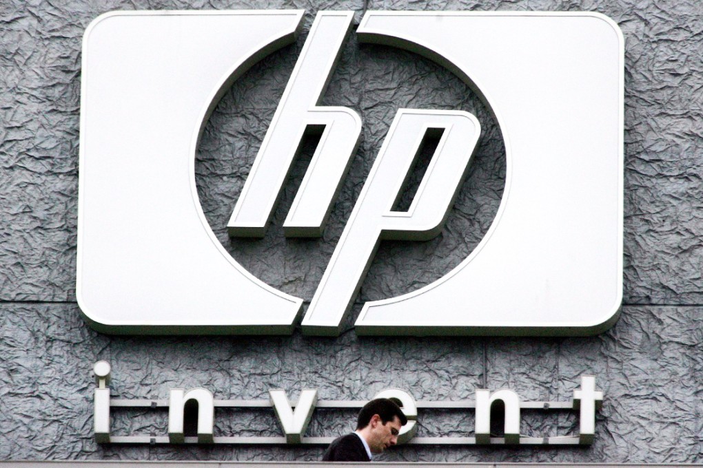 A man walks past the Hewlett Packard logo at its French headquarters in Issy le Moulineaux, western Paris. Photo: Reuters