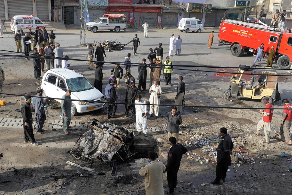 Pakistani security officials examine the site of the bomb explosion in Quetta on Saturday. Photo: AFP
