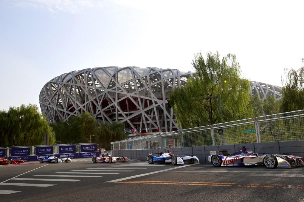 Electric cars whiz past Beijing's National Stadium during the inaugural Formula E Championship race yesterday. Photo: Reuters