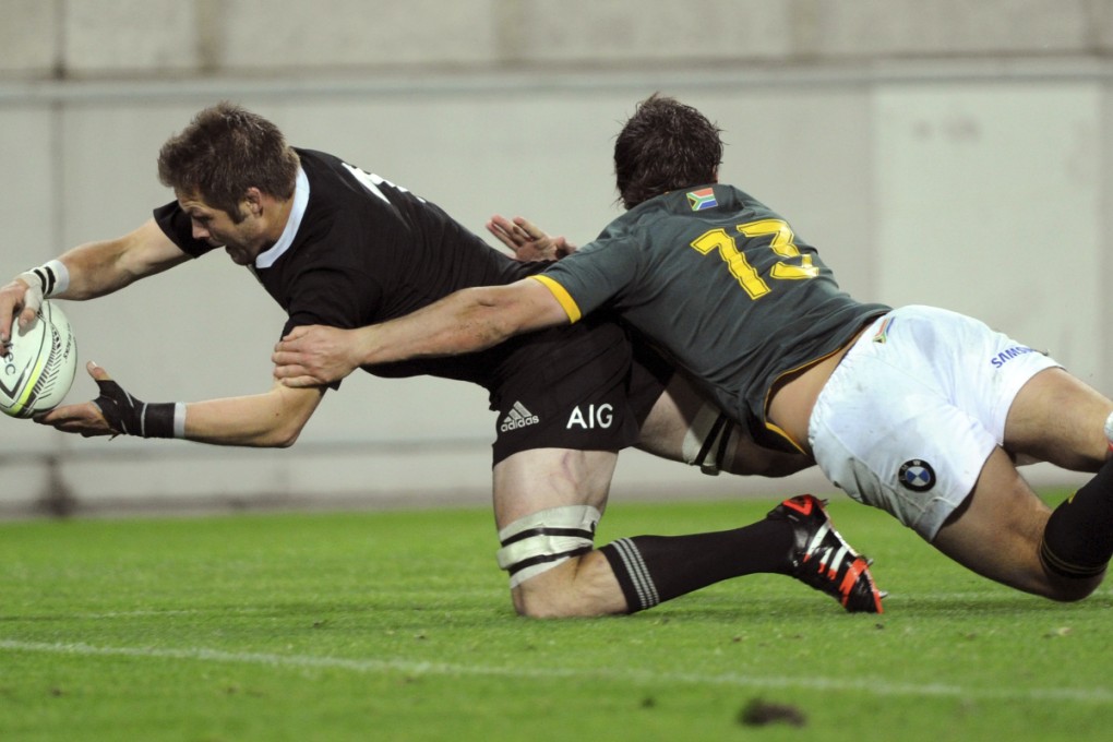 All Blacks captain Richie McCaw dives in at the corner to score in the tackle of South Africa's Jan Serfontein in the clash at Westpac Stadium in Wellington. Photos: AP