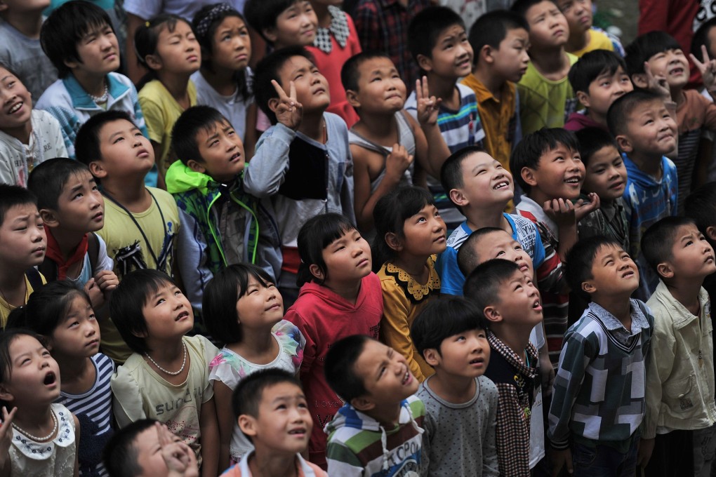 Students pose for a photo at a primary school for migrant children in Hefei, Anhui. Photo: Reuters