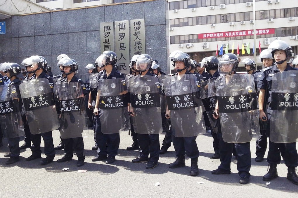 Police in anti-riot gear guard the government offices in Boluo county in Guangdong. The photo was provided by a rally participant who wished to remain anonymous. Photo: AP