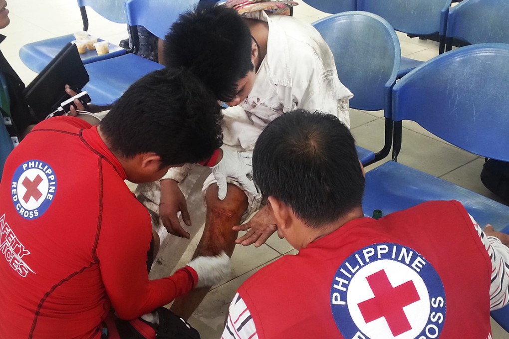 Red Cross workers tend to a passenger. Photo: AP
