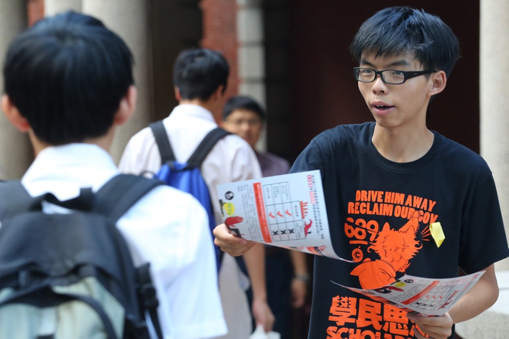 Scholarism convenor Joshua Wong distribute leaflets to secondary students.