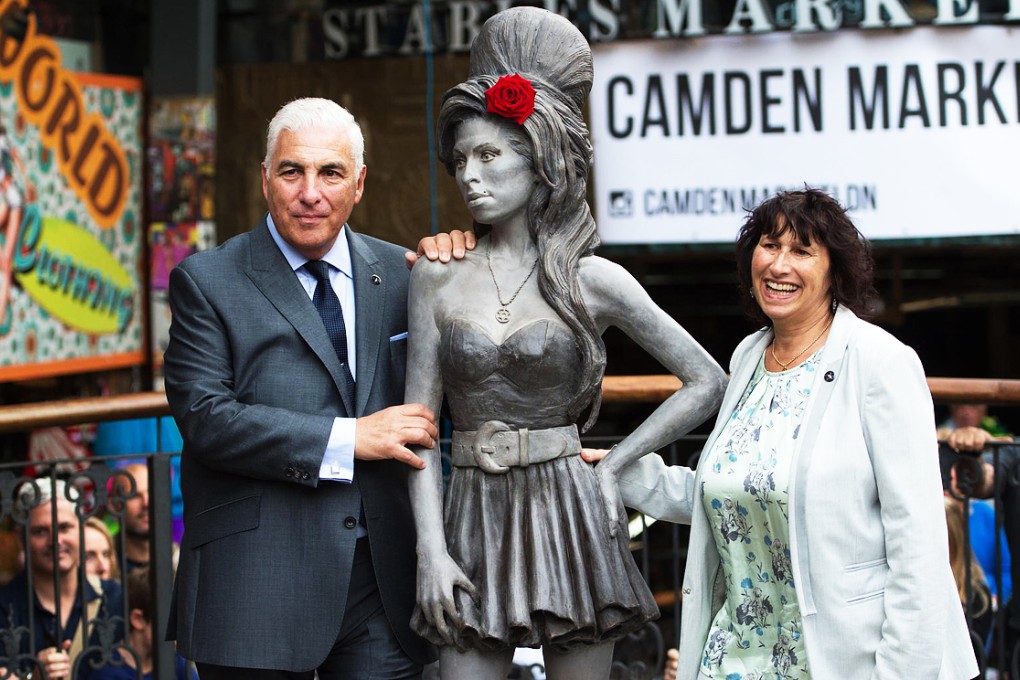 Mitch and Janis Winehouse with daughter Amy's statue. Photo: AP