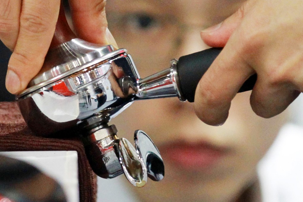 Getting a handle on the perfect cup of coffee at the Hong Kong Barista Championship. The event reflects a growing passion for coffee in the city. Photo: Edward Wong
