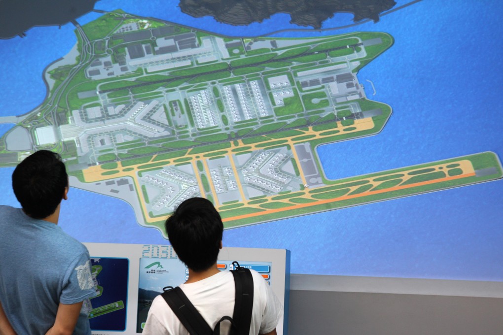 People look at a plan for the proposed runway. Photo: Dickson Lee