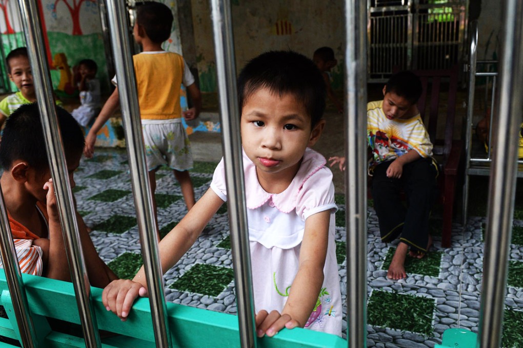 A young girl looks at visitors inside a state-run orphanage in Ba Vi district, in the outskirts of Hanoi. Photo: AFP