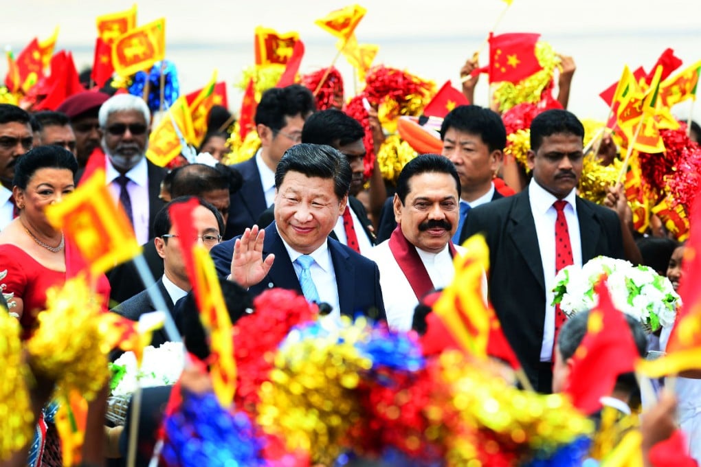 Xi Jinping gestures as Sri Lankan President Mahinda Rajapaksa looks on during a welcome ceremony at the Bandaranaike International Airport. Photo: AFP