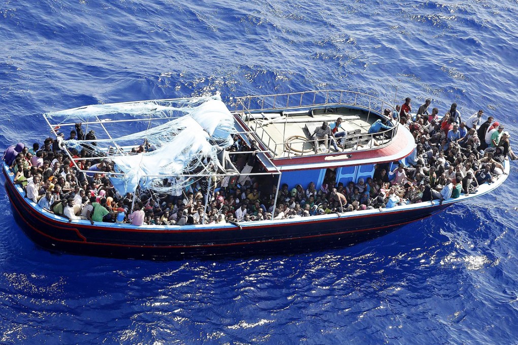 Hundreds of illegal migrants crowd a boat as they head to the Italian mainland after being rescued from a sinking vessel. Photo: EPA