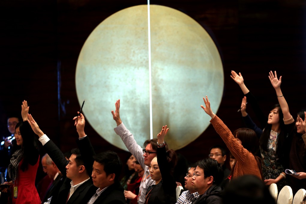 Journalists raise their hands for questions during a national party congress in Beijing. Photo: Xinhua