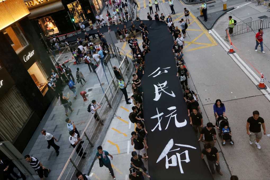Protestors march from Causeway Bay to Chater Road during Occupy Central with Love and Peace's "Black Cloth March".