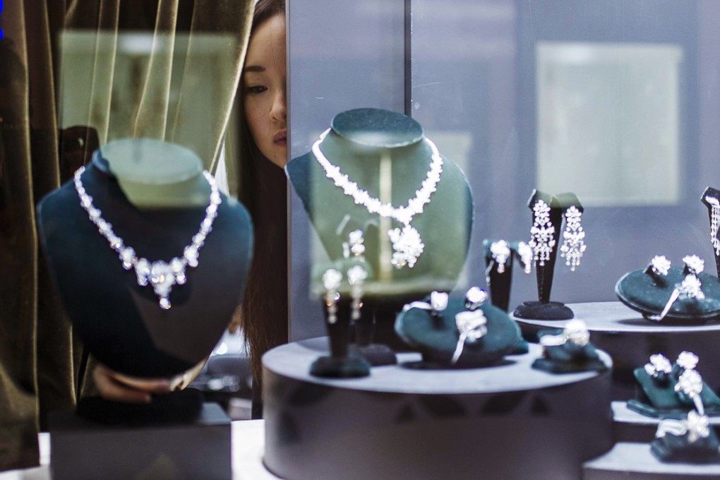 A vendor checks a display prior to the opening. The Hong Kong Jewellery and Gem Fair features nearly 3,700 exhibitions from 49 countries and regions. Photo: AFP