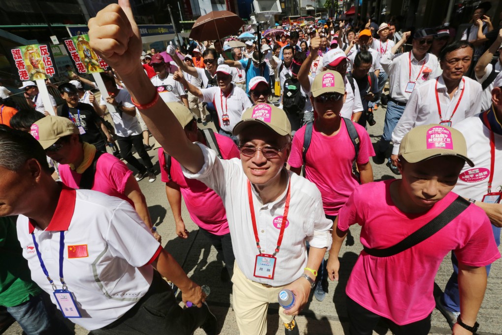 Robert Chow Yung (centre) of the Alliance for Peace and Democracy at an anti-Occupy Central march last month. Photo: Felix Wong