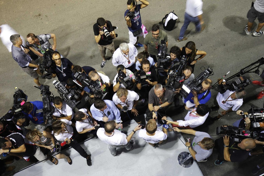 The press pack mobs Mercedes driver Nico Rosberg at the Marina Bay street circuit paddock ahead of this weekend's Singapore Grand Prix. Photo: Reuters
