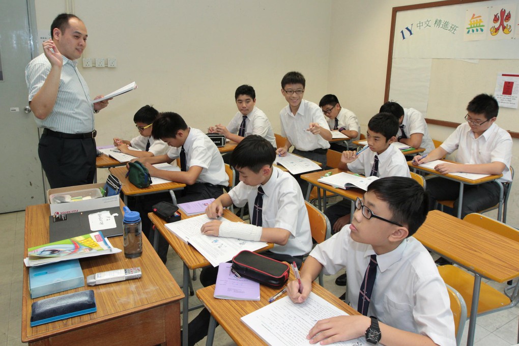 Eric Chung leads a class of 12 students at Wah Yan College. Small-class teaching allows for greater teamwork and more student interaction, experts say. Photo: Bruce Yan