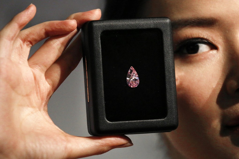 An 8.41-carat pear-shaped internally flawless fancy vivid purple-pink diamond is displayed during a Sotheby's preview in Hong Kong. Photo: Reuters