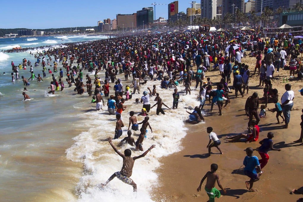People visit the beach on New Year's Day in Durban in this January 1, 2014 file photo. Photo: Reuters