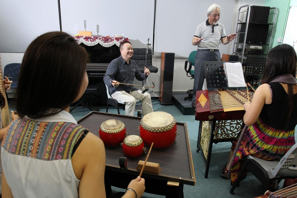 Wang Peiyu (left) plays the erxian while Kwok Hang-kei conducts musicians rehearsing for the Scenes of Guangdong concert, which features Chiu Chow music. Photo: May Tse