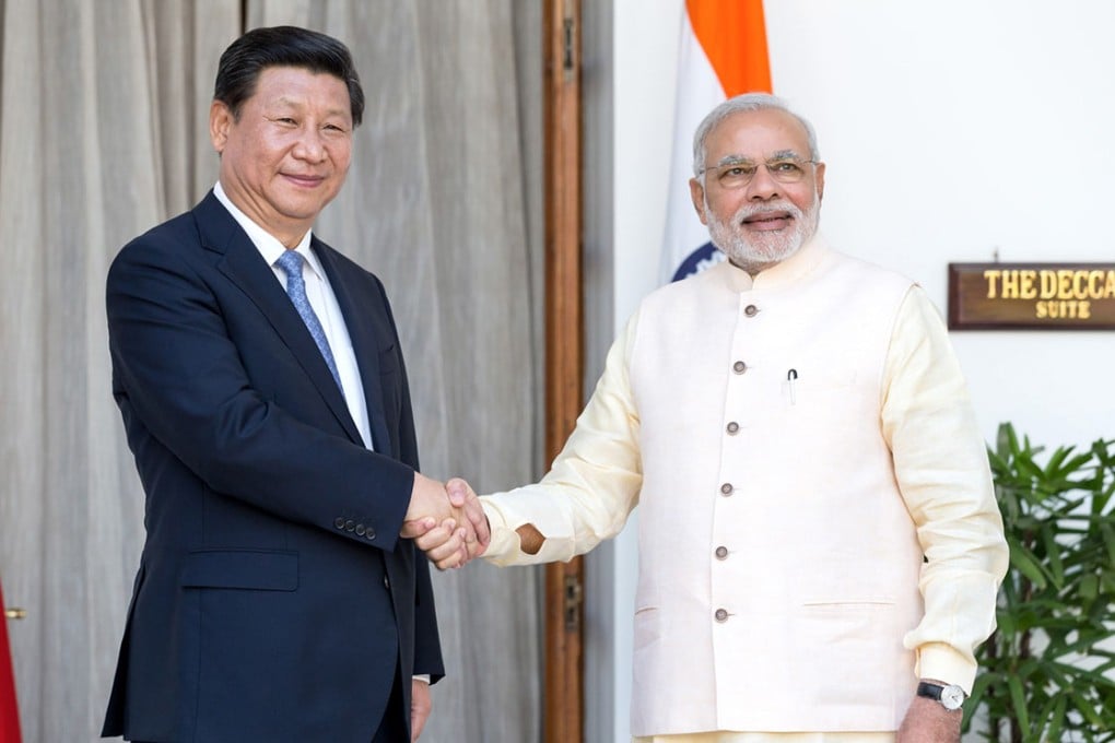 Chinese president Xi Jinping (left) shakes hands with Indian prime minister Narendra Modi as they arrive for delegation talks in New Delhi.