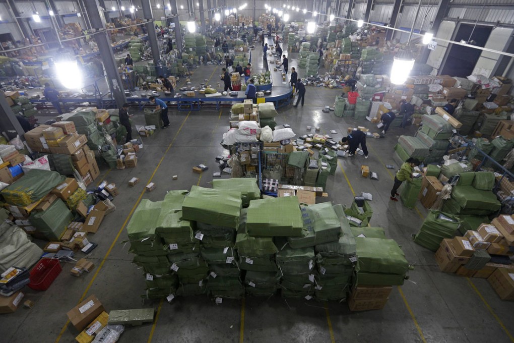 Employees sort packages along a convey belt at a hub of ZTO Express.