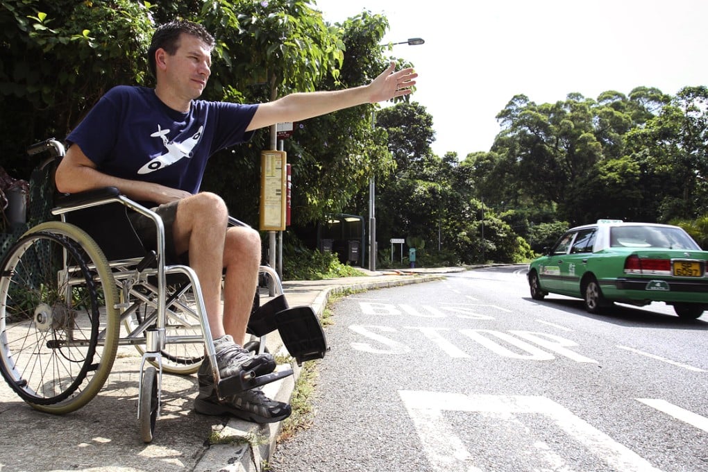 Paul Letters attempts to hail a taxi at Wong Chuk Wan in Sai Kung. Photo: Dickson Lee