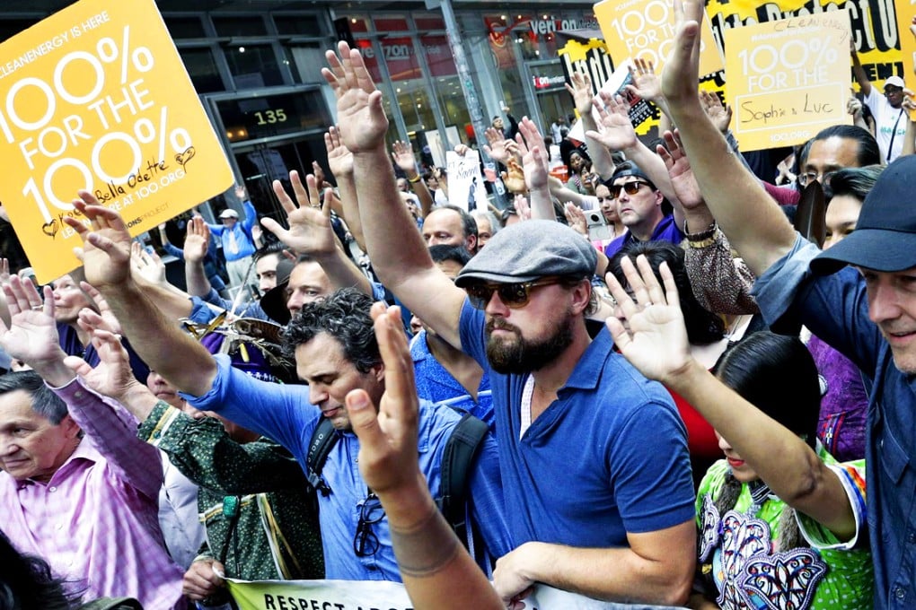 Hollywood stars Mark Ruffalo, Leonardo DiCaprio and Edward Norton raise hands at the climate march in New York. Photo: EPA