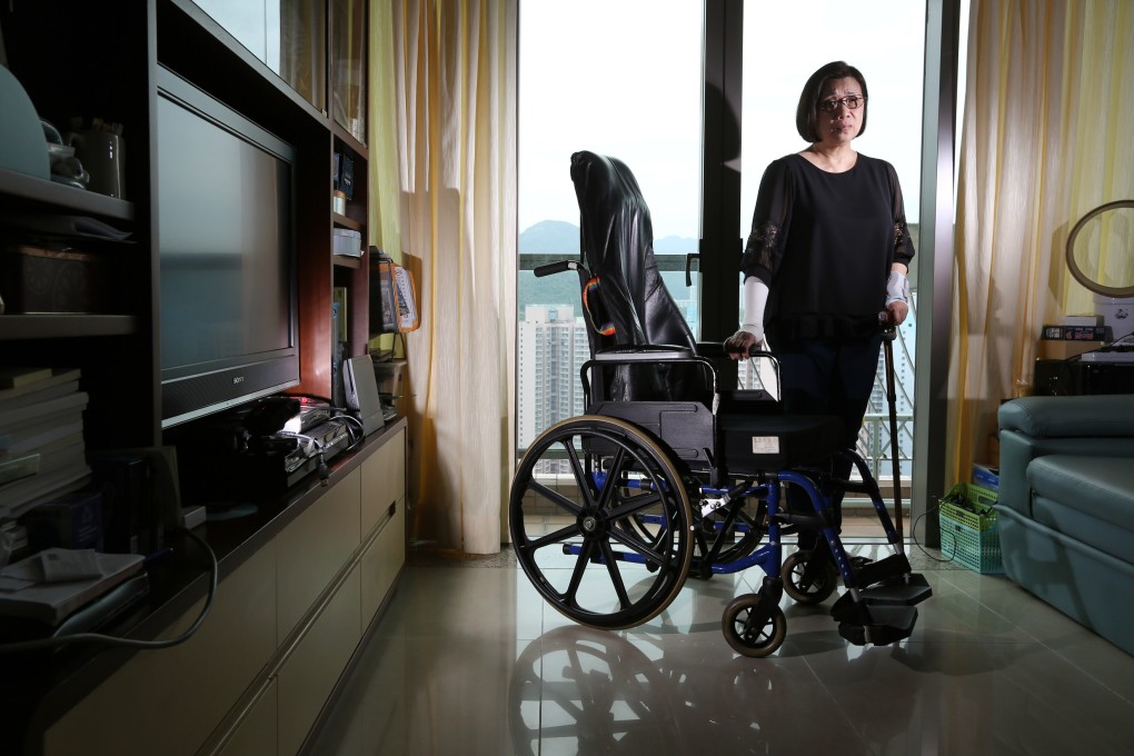 Crutch in hand, 62-year-old Au Wai-chun stands next to her wheelchair in a Tseung Kwan O apartment this weekend, ahead of yesterday’s sentencing. Photo: Felix Wong