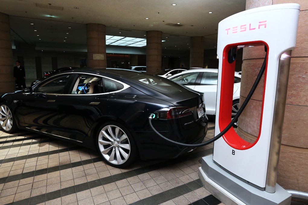 A Tesla Motors Model S electric sedan on charge outside a hotel in Tokyo, Japan. Photo: Bloomberg