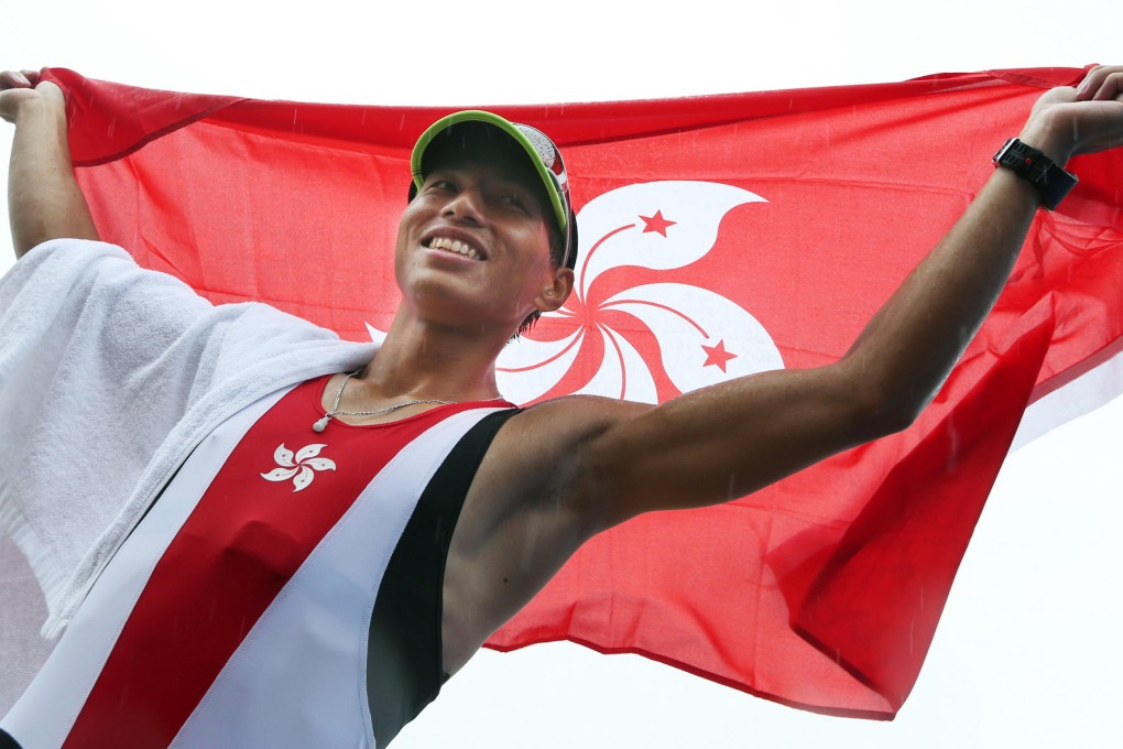Hong Kong's Lok Kwan-hoi raises the Bauhinia flag after winning the gold medal in the men's lightweight sculls at the Asian Games at Chungju Tangeum Lake. Photo: Nora Tam