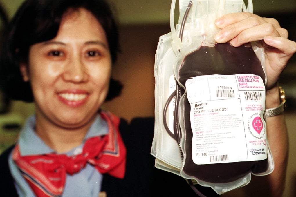 A Chinese nurse holds up a bag of freshly drawn blood. One Chinese county is offering incentives for generous blood donors. Photo: SCMP Pictures