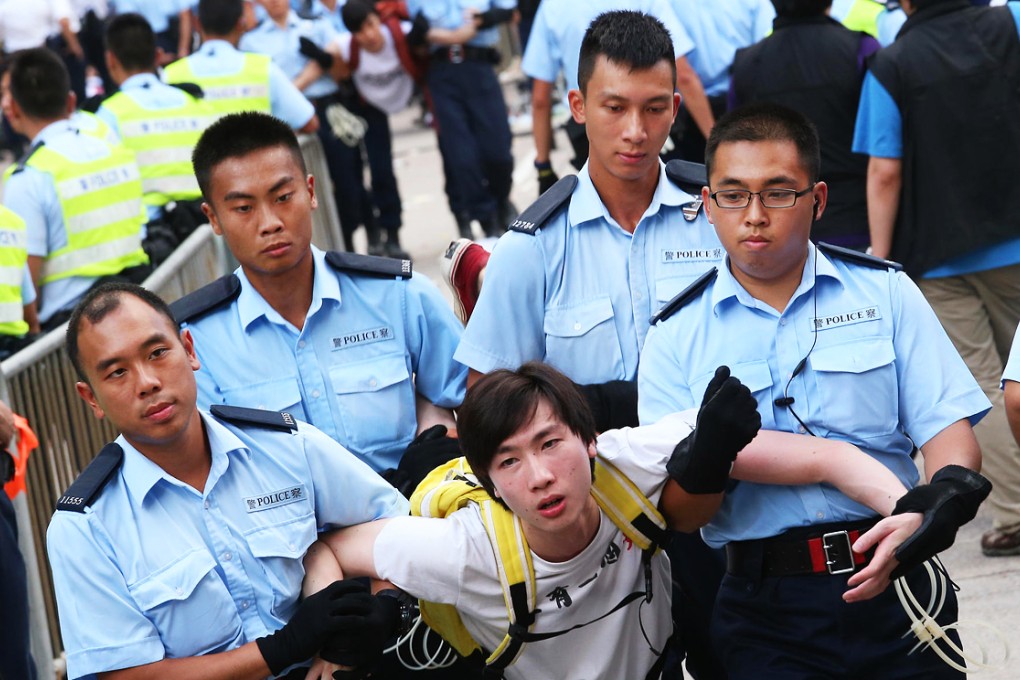 Police remove a protester at Chater Road in July. Photo: David Wong