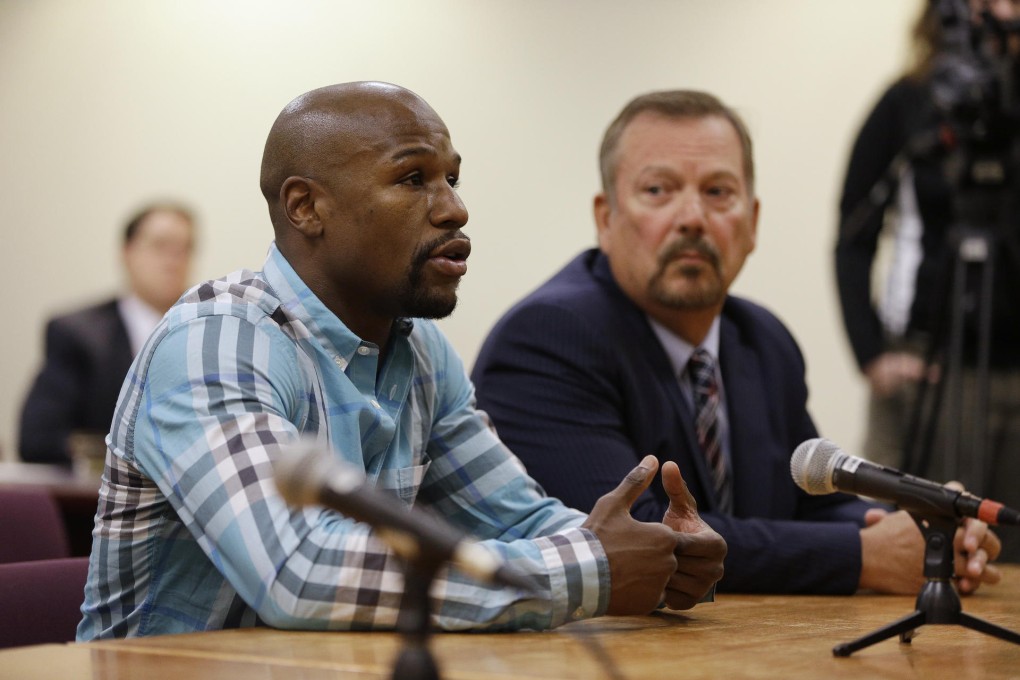 Boxer Floyd Mayweather Jnr appears with attorney Shane Emerick before the Nevada Athletic Commission in Las Vegas. Photo: AP
