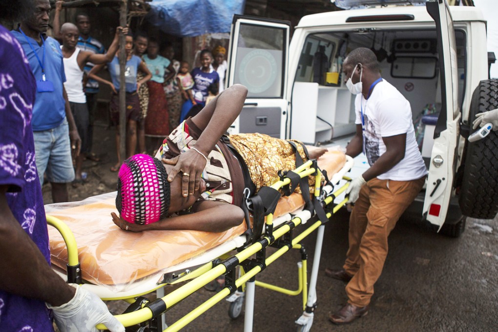 A pregnant woman suspected of contracting Ebola is lifted by stretcher into an ambulance in Freetown, Sierra Leone. Photo: Reuters