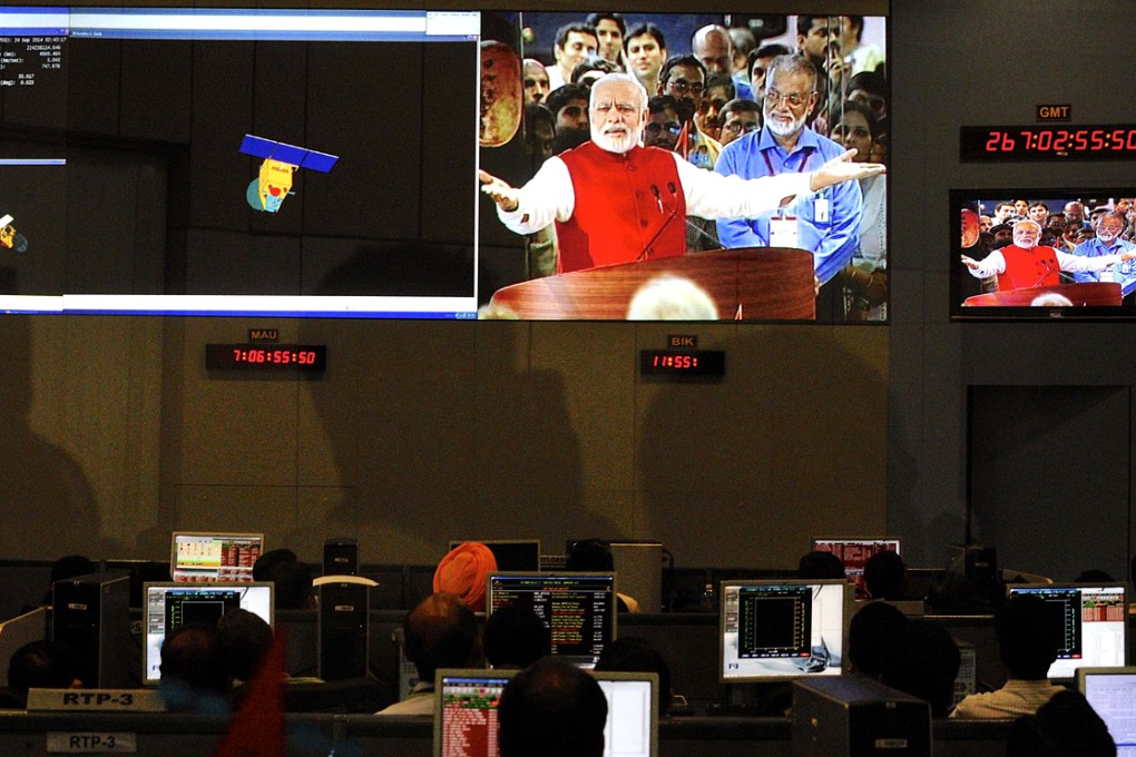 Control centre staff watch Narendra Modi on screens yesterday. Photo: Reuters