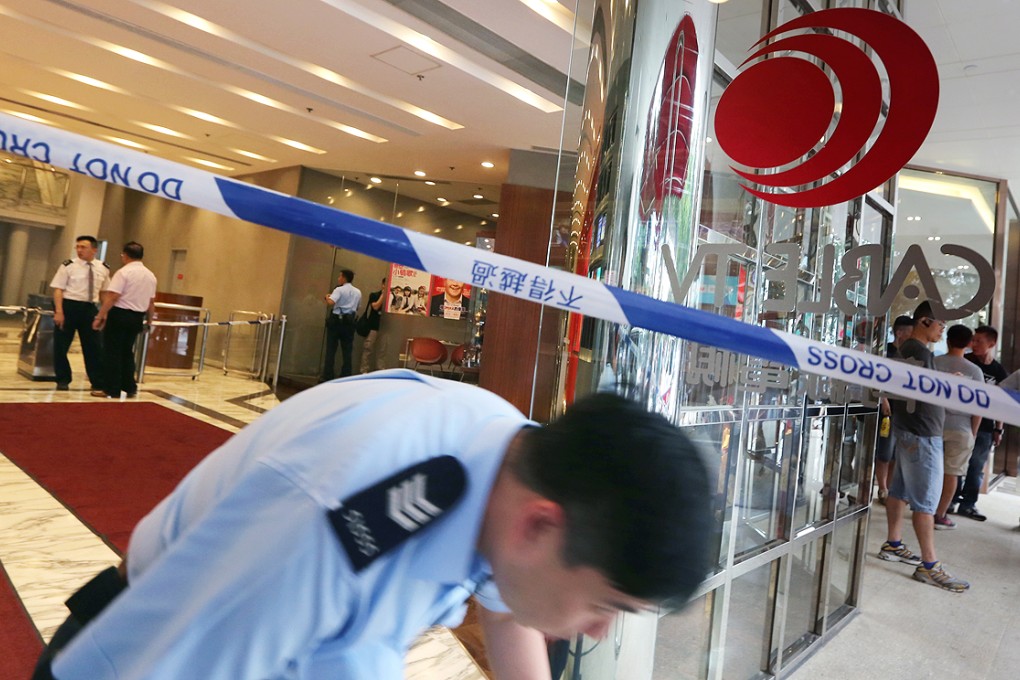 Police cordon off the scene to investigate a man at the i-Cable TV offices, who allegedly attacked a security guard with a machete. Photo: Felix Wong